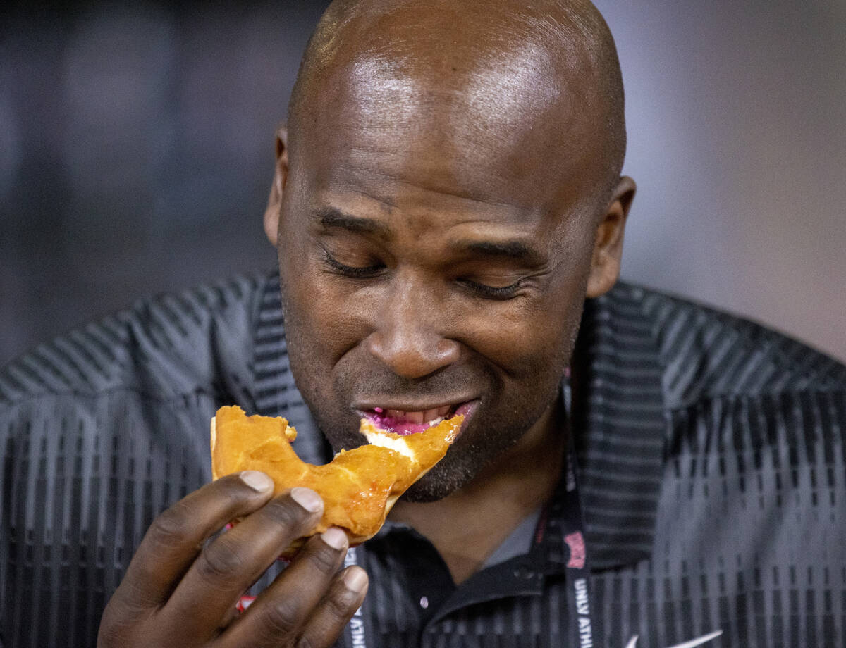 Former UNLV offensive lineman Tony Terrell competes in a doughnut eating contest for breast can ...