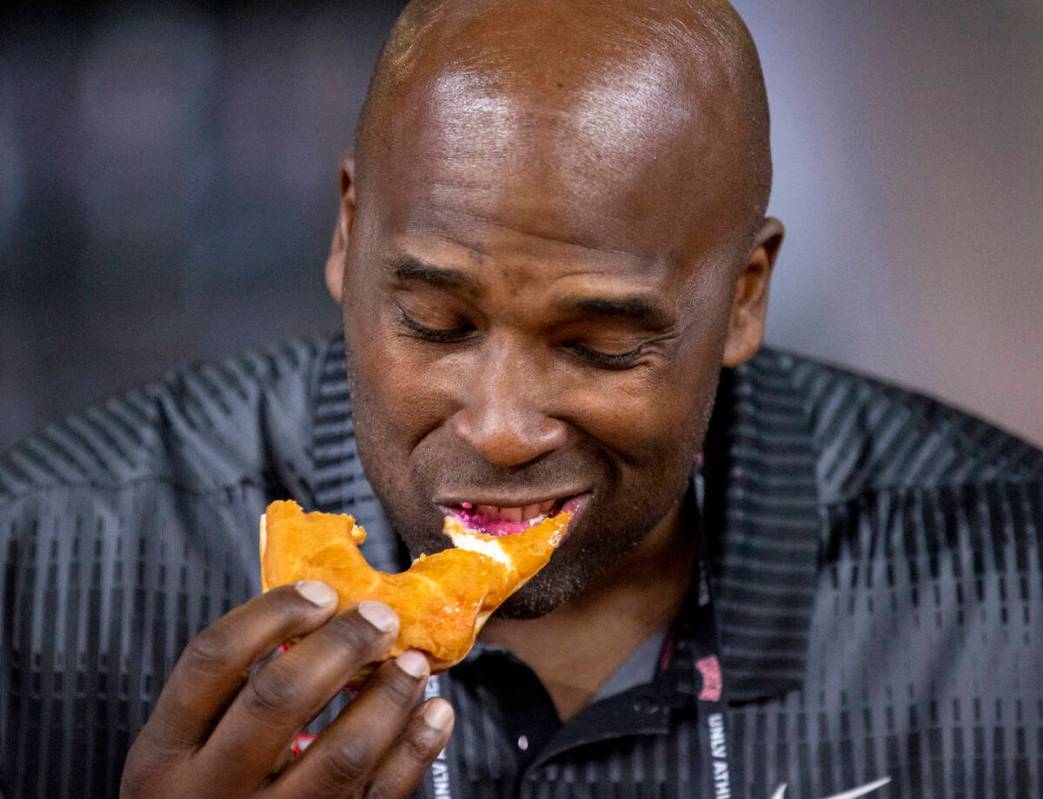 Former UNLV offensive lineman Tony Terrell competes in a doughnut eating contest for breast can ...