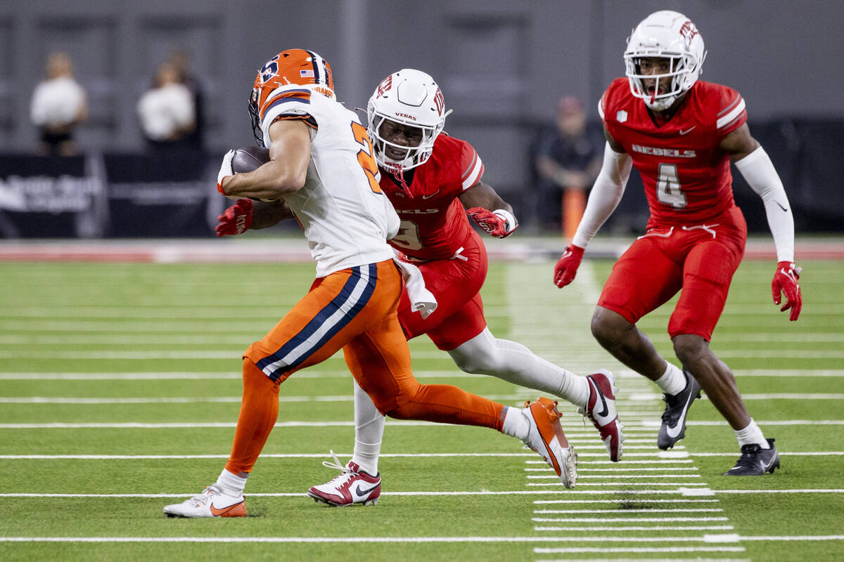 UNLV defensive back Jett Elad (9) tackles Syracuse Orange wide receiver Trebor Pena (2) during ...