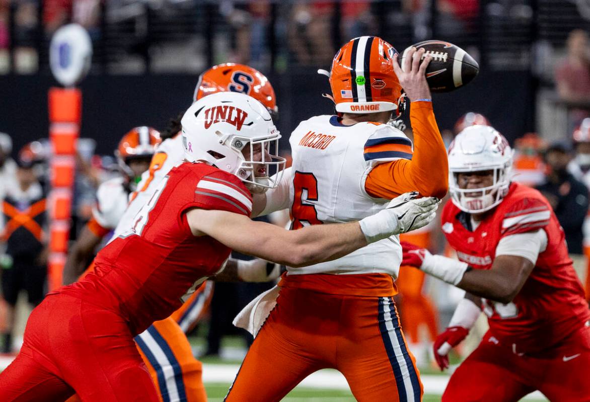 UNLV defensive lineman Fisher Camac (28) disrupts Syracuse Orange quarterback Kyle McCord (6) f ...