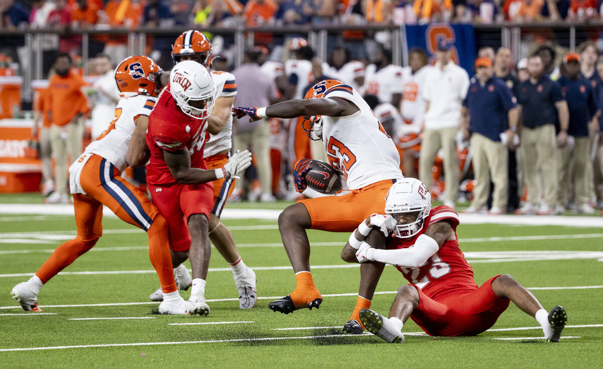 UNLV defensive back Saadite Green Jr. (23) tackles Syracuse Orange running back Yasin Willis (2 ...