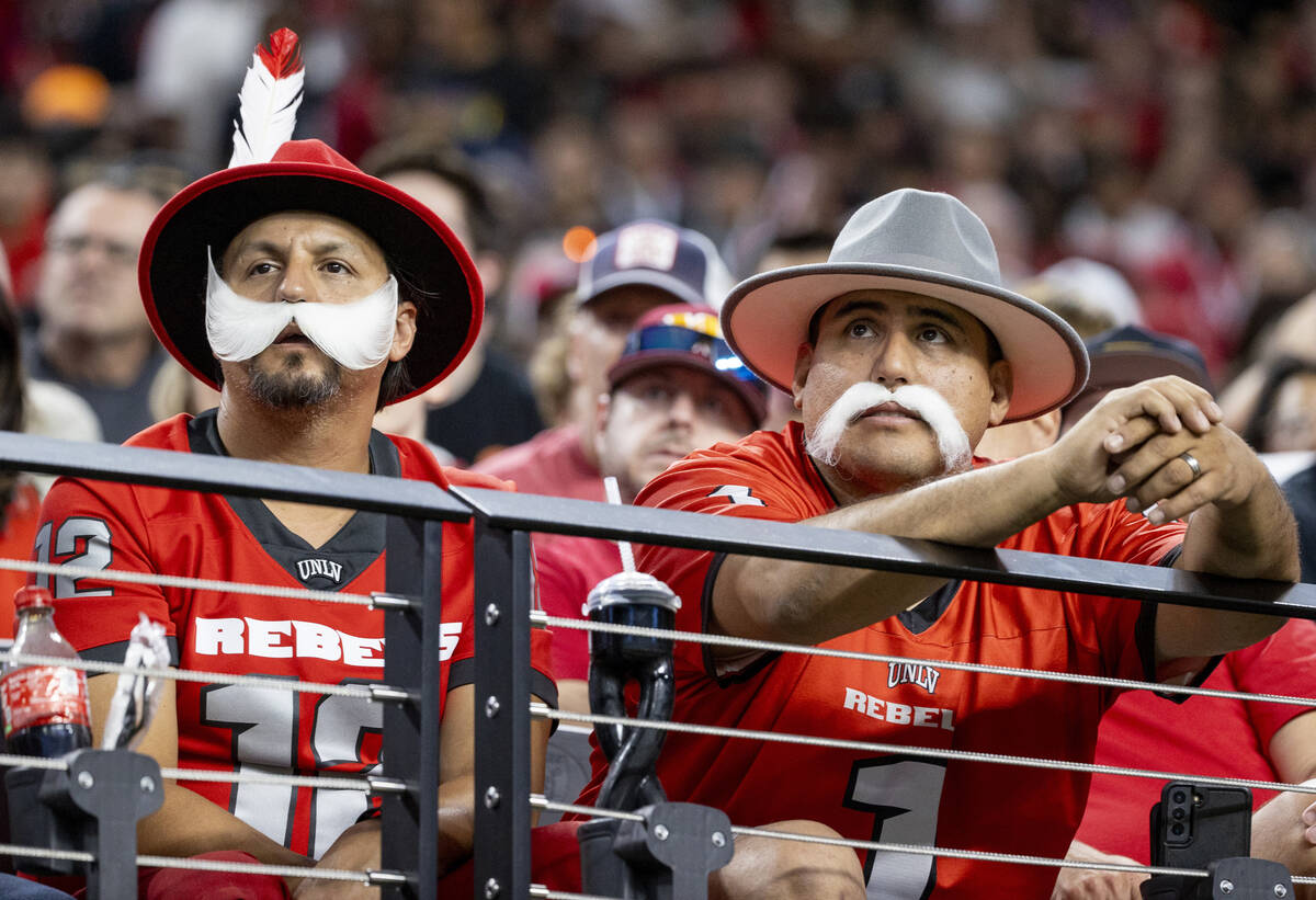 UNLV fans dressed as Rebels watch the college football game against the Syracuse Orange at Alle ...