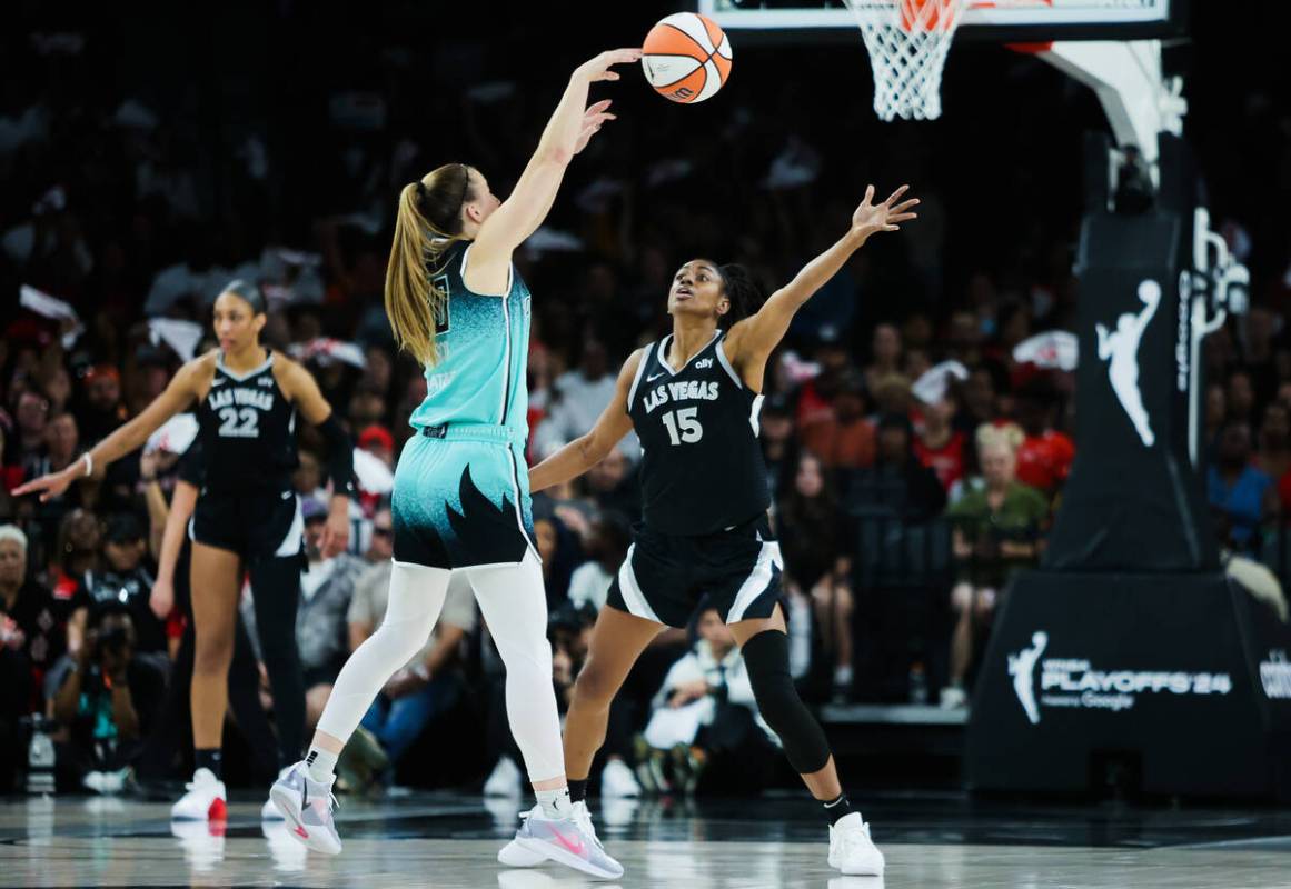 New York Liberty guard Sabrina Ionescu (20) passes the ball to a teammate as Aces guard Tiffany ...