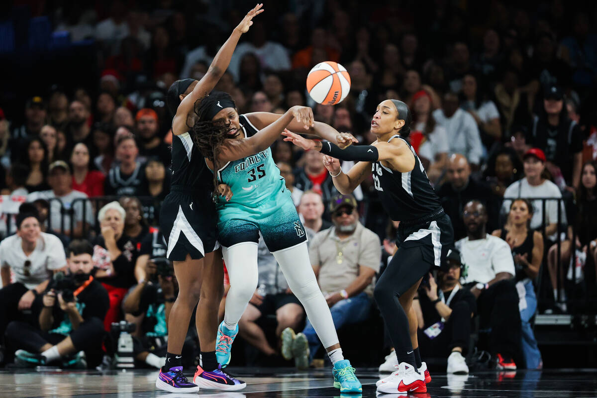 New York Liberty forward Jonquel Jones (35) throws the ball to a teammate as Aces guard Jackie ...