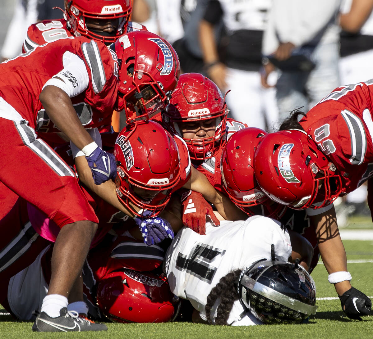 Arbor View players pile on top of Desert Pines senior Isaiah Te'o (4) during the high school fo ...