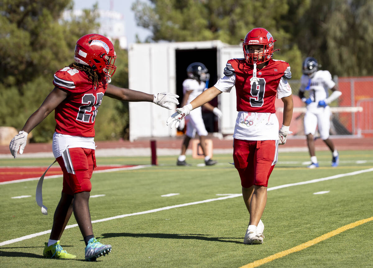 Arbor View wide receiver Kai Cypher (9) celebrates a touchdown with running back Nylen Johnson ...