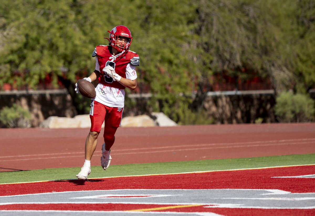 Arbor View wide receiver Kai Cypher (9) scores a touchdown during the high school football game ...