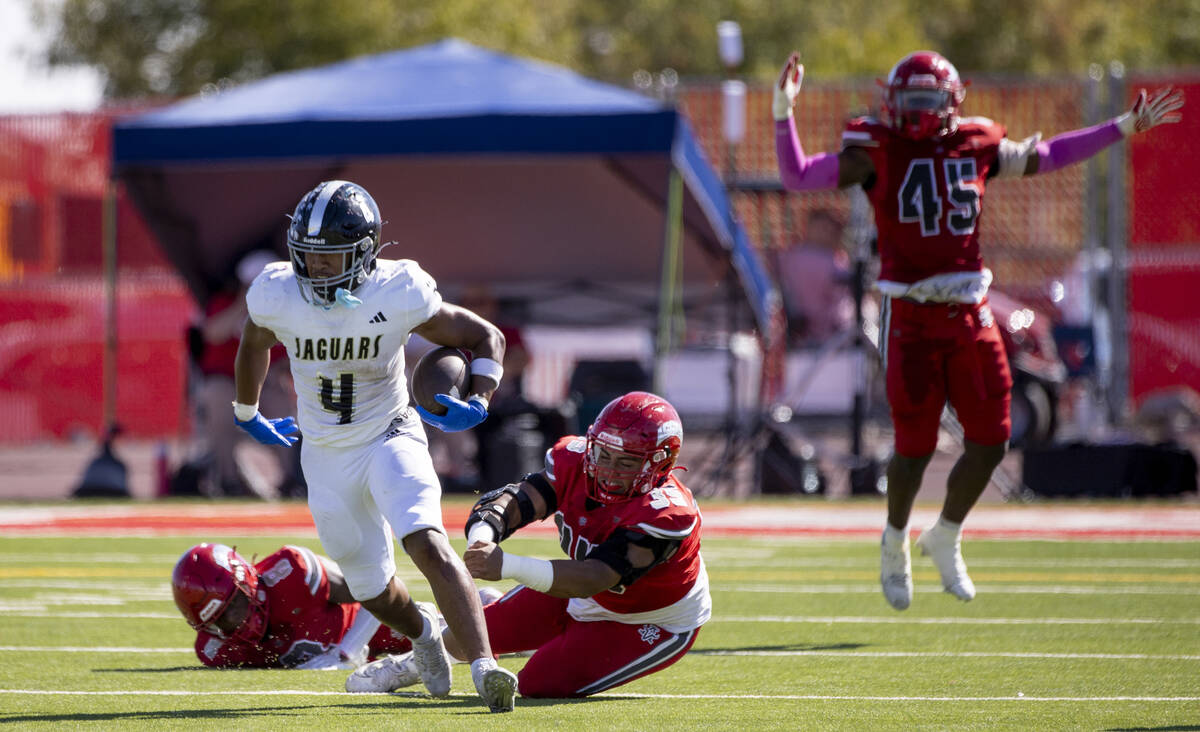 Desert Pines senior Isaiah Te'o (4) avoids Arbor View tacklers during the high school football ...