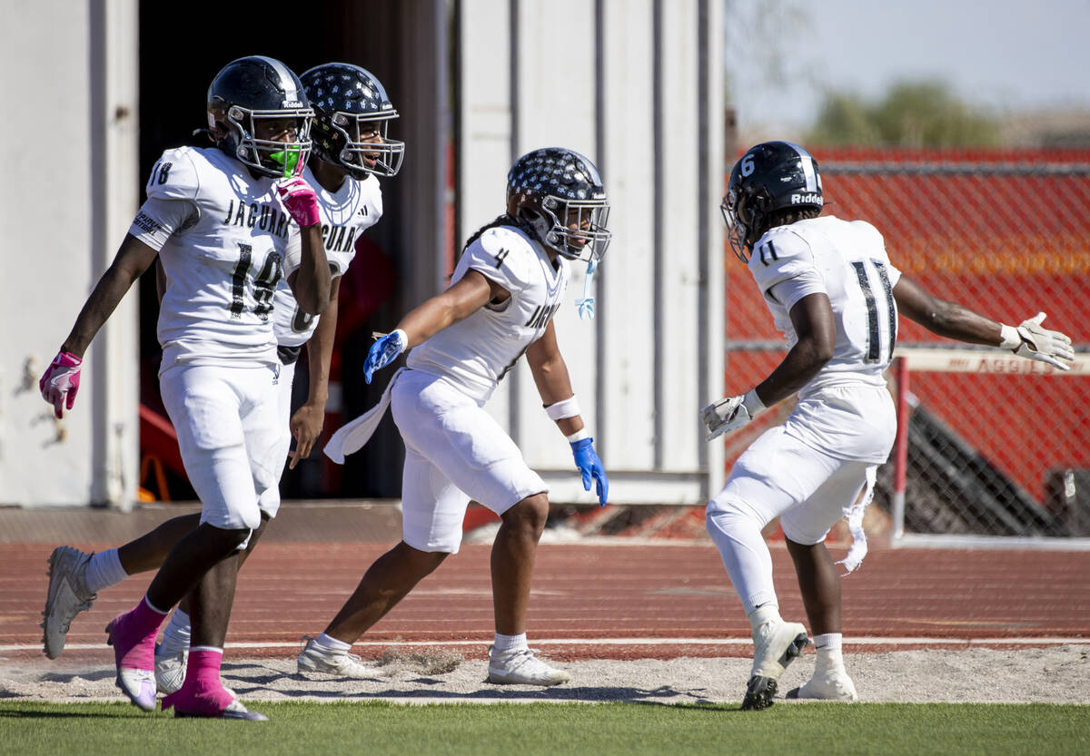 Desert Pines senior Isaiah Te'o (4) celebrates with teammates after scoring a touchdown during ...