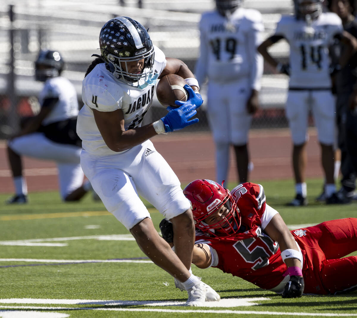 Desert Pines senior Isaiah Te'o (4) avoids Arbor View linebacker Xaiden Quenga (50) during the ...