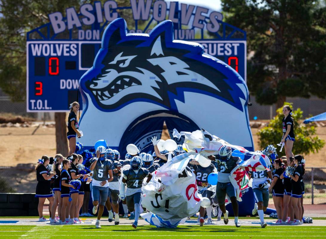 Basic players take the field to battle Coronado during the first half of their NIAA football ga ...