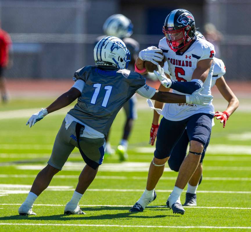 Coronado defensive back JJ Buchanan (6) brushes off a tackle attempt after an interception by B ...