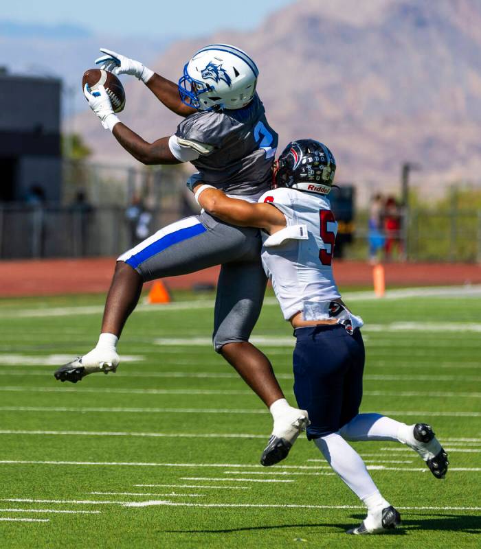 Basic wide receiver Parker Simmons (5) elevates for a catch while hit from behind by Coronado d ...