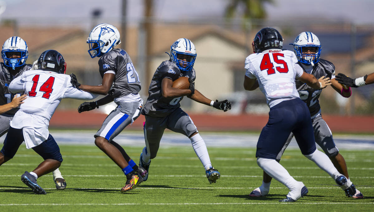 Basic fullback Elijah Jones (8) looks to blast through a gap as Coronado defensive end Aiden Gd ...