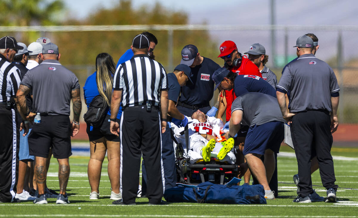 Coronado defensive back Scott "Bubba" Holper (13) is taken off the field by medical p ...