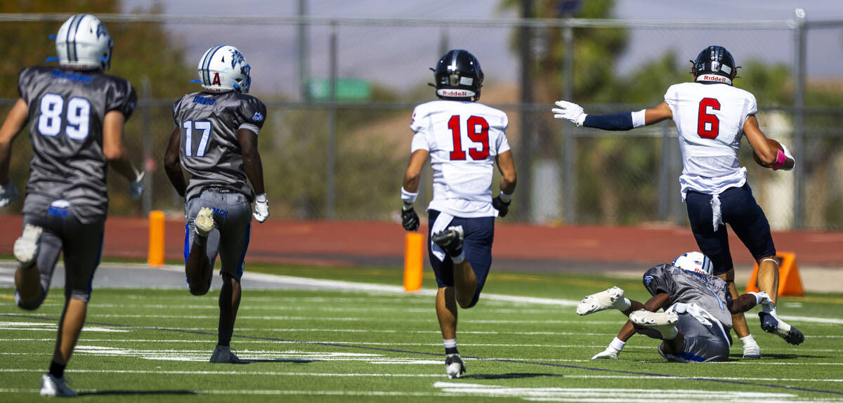 Coronado wide receiver JJ Buchanan (6) escapes a diving tackle attempt by Basic defensive back ...