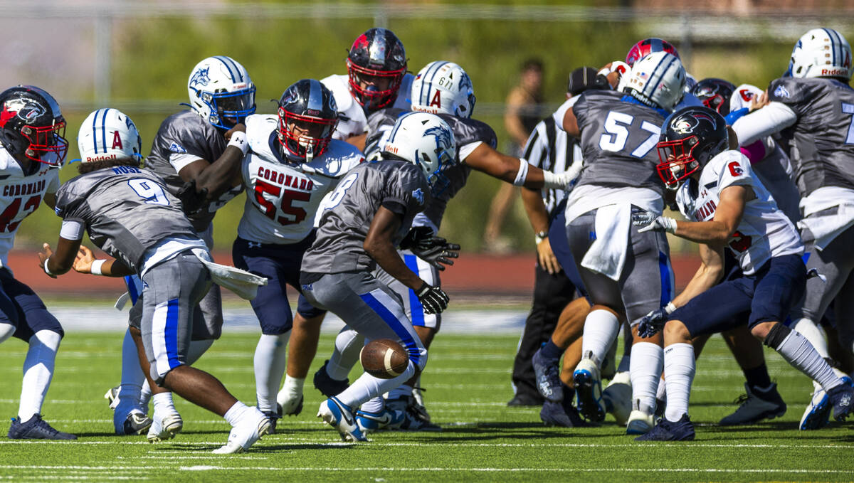 Basic fullback Elijah Jones (8) fumbles the ball as Coronado defenders move in during the first ...