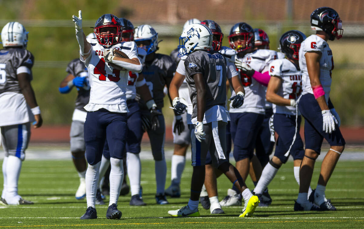 Coronado linebacker William Bittman (43) signals his fumble recovery and the new direction of p ...