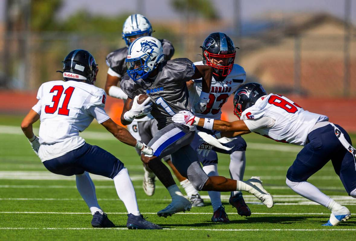 Basic running back Donovan Glover (1) is caught by Coronado defenders during the second half of ...