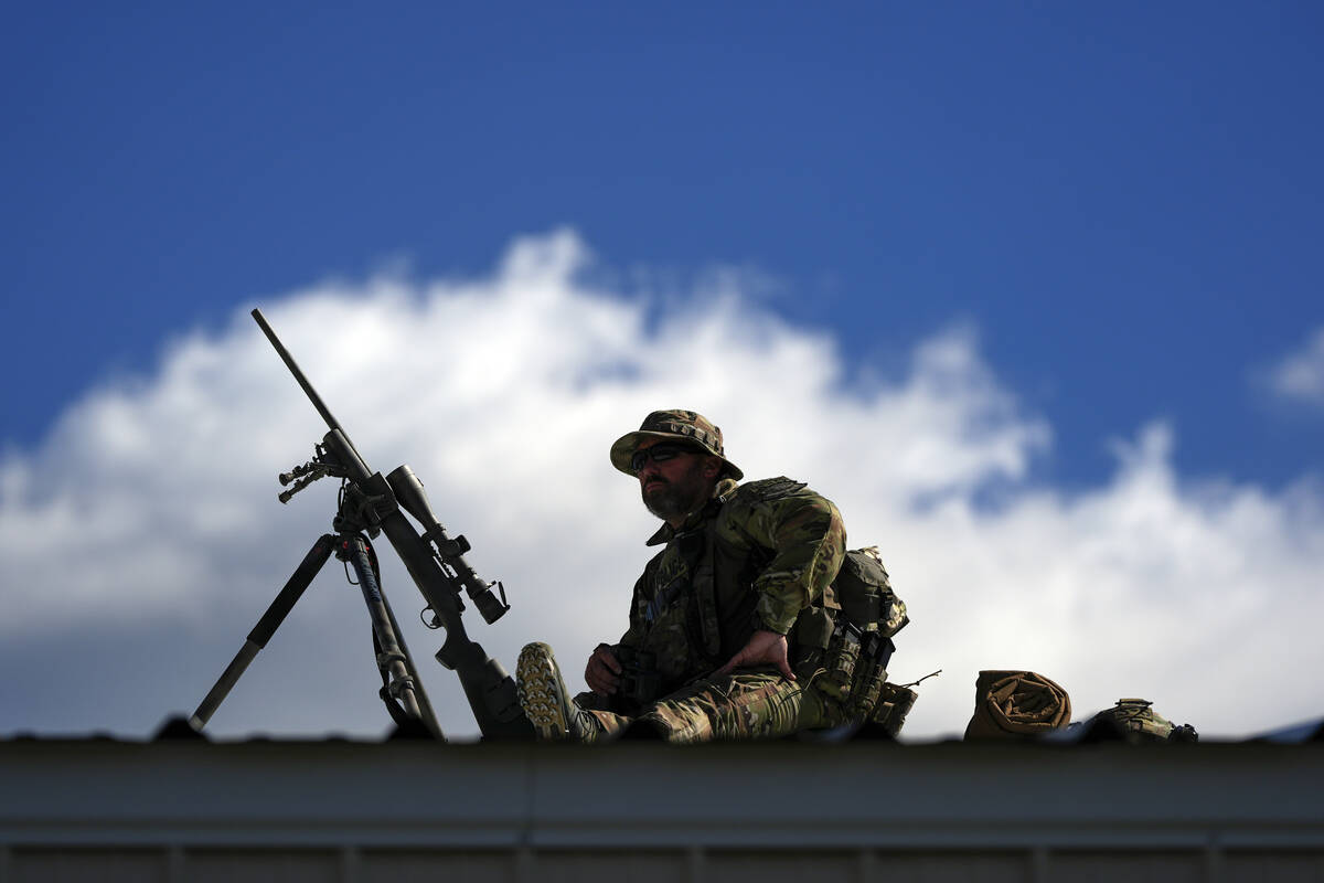 Law enforcement provides overwatch on a roof as supporters arrive before Republican presidentia ...