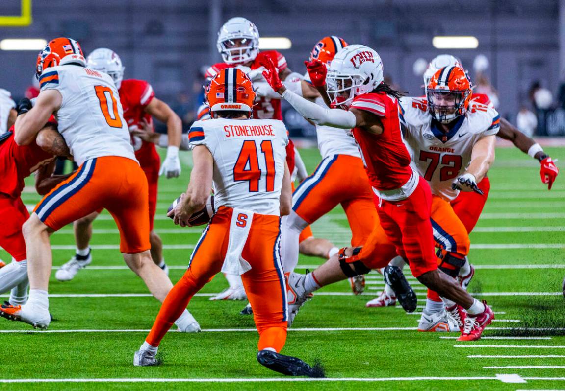 Syracuse Orange punter Jack Stonehouse (41) is unable to punt as UNLV wide receiver Ricky White ...