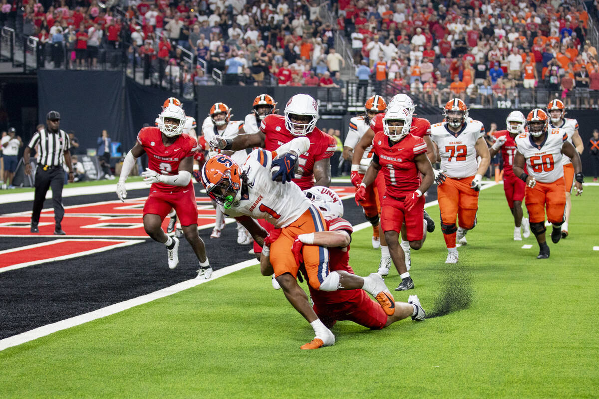 UNLV linebacker Jackson Woodard (7) attempts to tackle Syracuse Orange running back LeQuint All ...