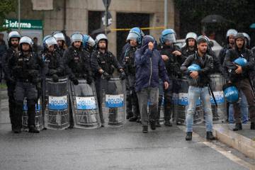 Italian Police officers patrol during a protest in Rome, Saturday, Oct. 5, 2024. Pro-palestinia ...