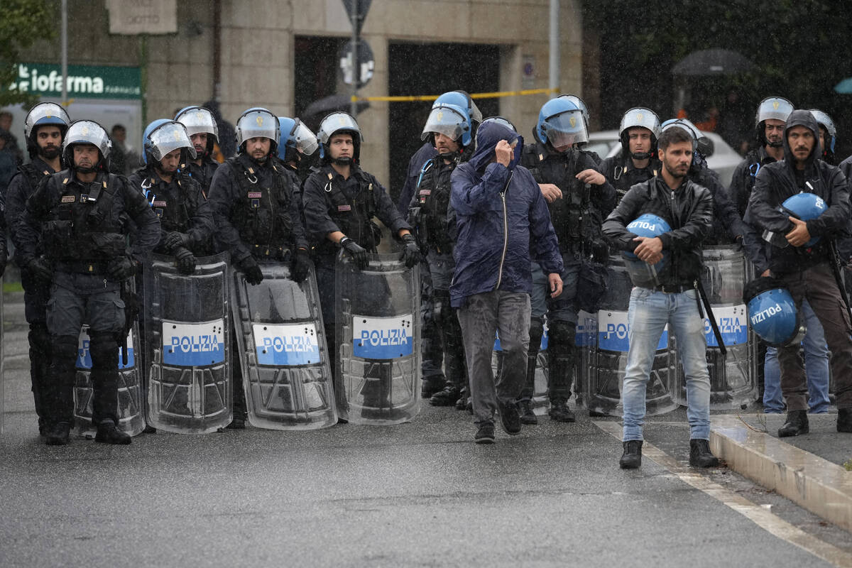 Italian Police officers patrol during a protest in Rome, Saturday, Oct. 5, 2024. Pro-palestinia ...