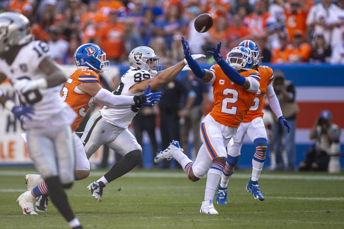 Denver Broncos cornerback Pat Surtain II (2) reaches to intercept a pass intended for Raiders t ...