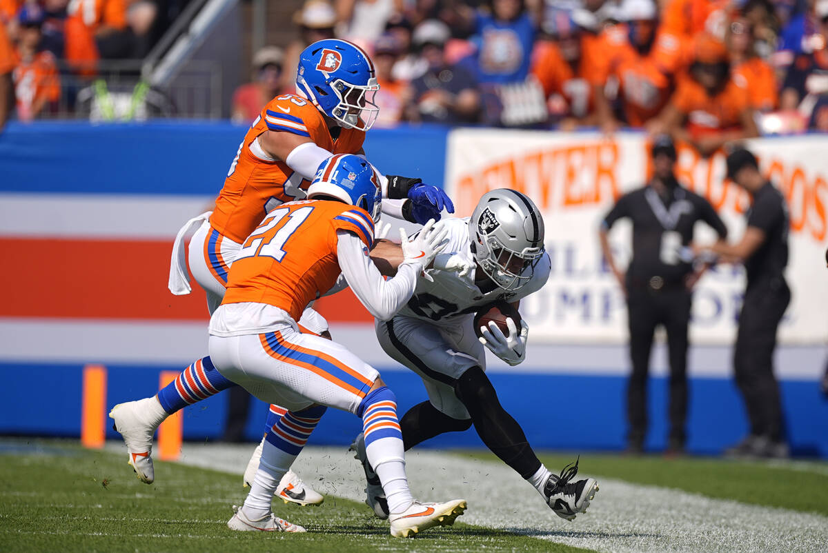 Las Vegas Raiders tight end Brock Bowers (89) is pushed out of bounds during the first half of ...