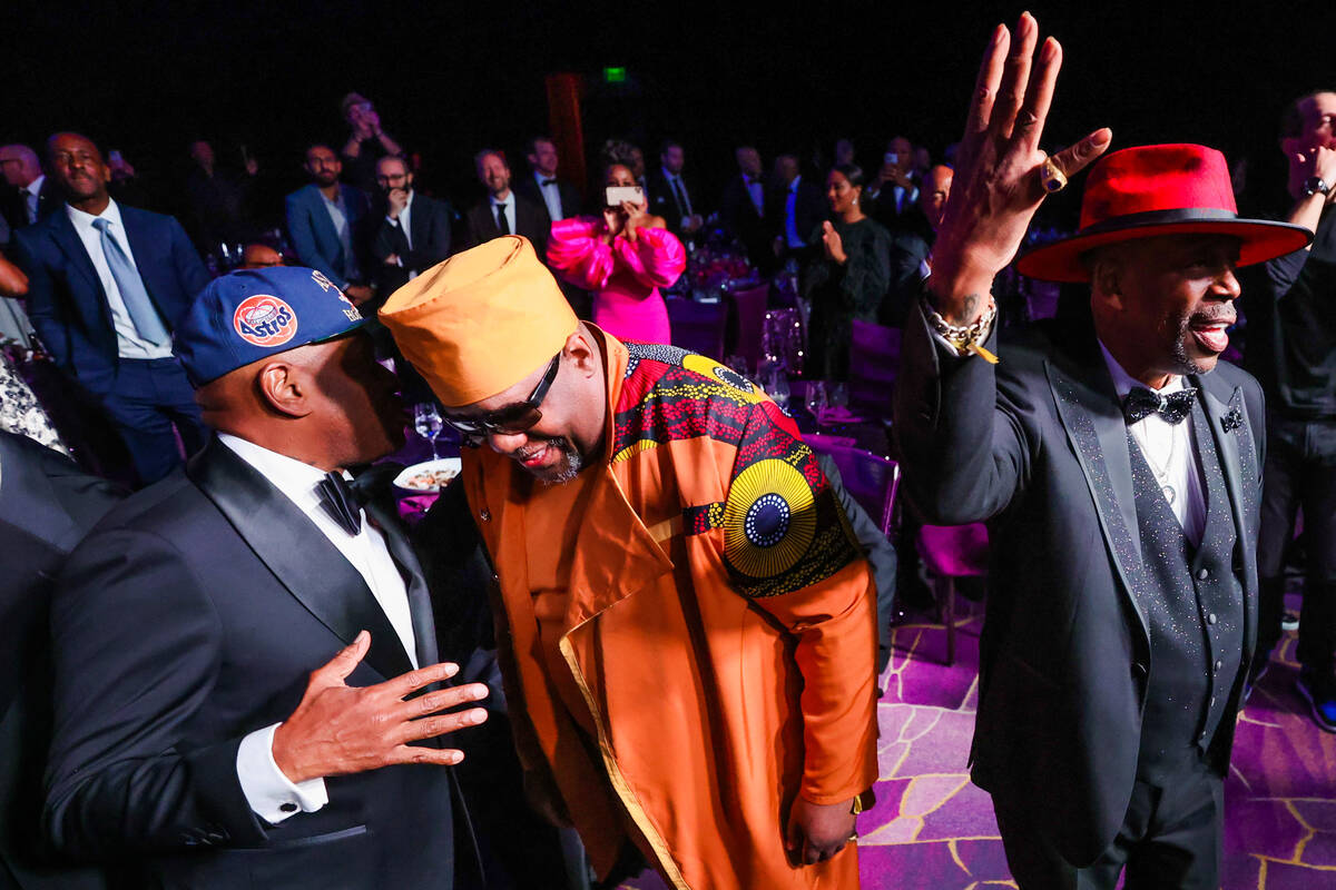 Scarface, left, chats with Kool Moe Dee, right, as Grandmaster Caz dances to a performances by ...