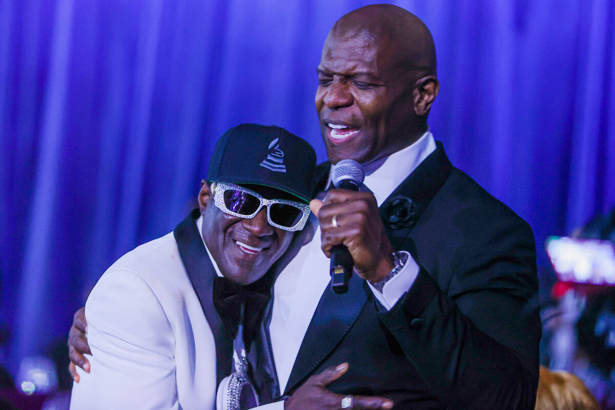 Flavor Flav, left, hugs Terry Crews as he hosts the Paid in Full Foundation’s Hip Hop Gr ...