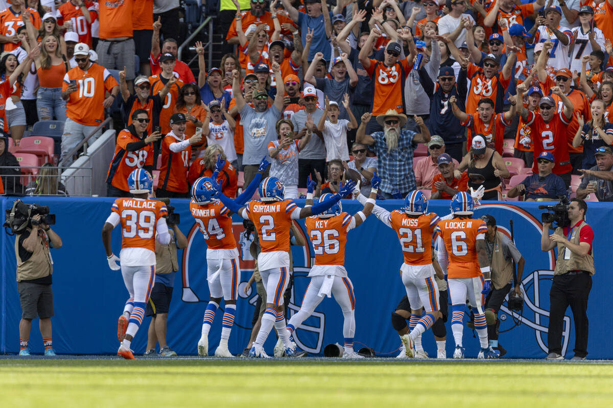 Denver Broncos cornerback Pat Surtain II (2) and other defenders celebrate his second intercept ...