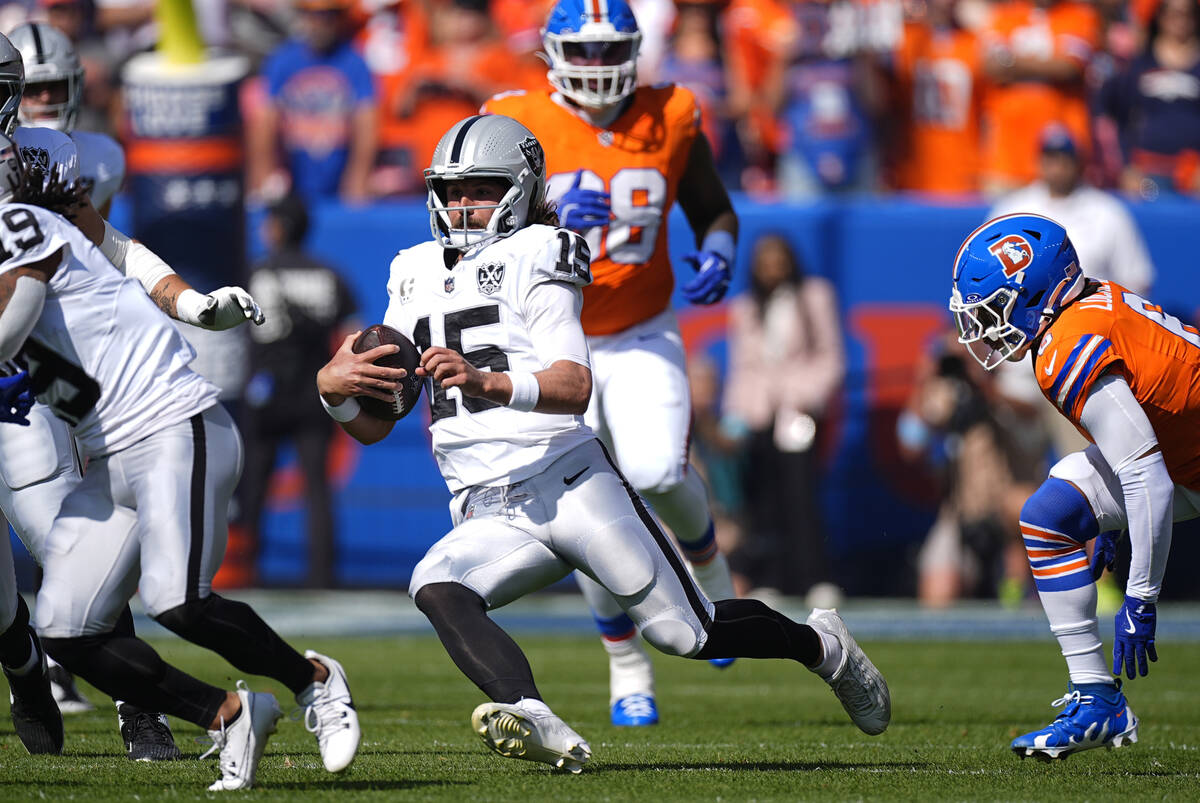 Las Vegas Raiders quarterback Gardner Minshew scrambles during the first half of an NFL footbal ...