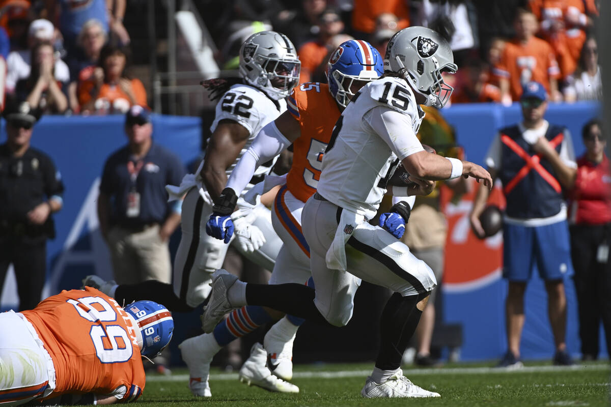 Las Vegas Raiders quarterback Gardner Minshew (15) pulls away from Denver Broncos linebacker Co ...