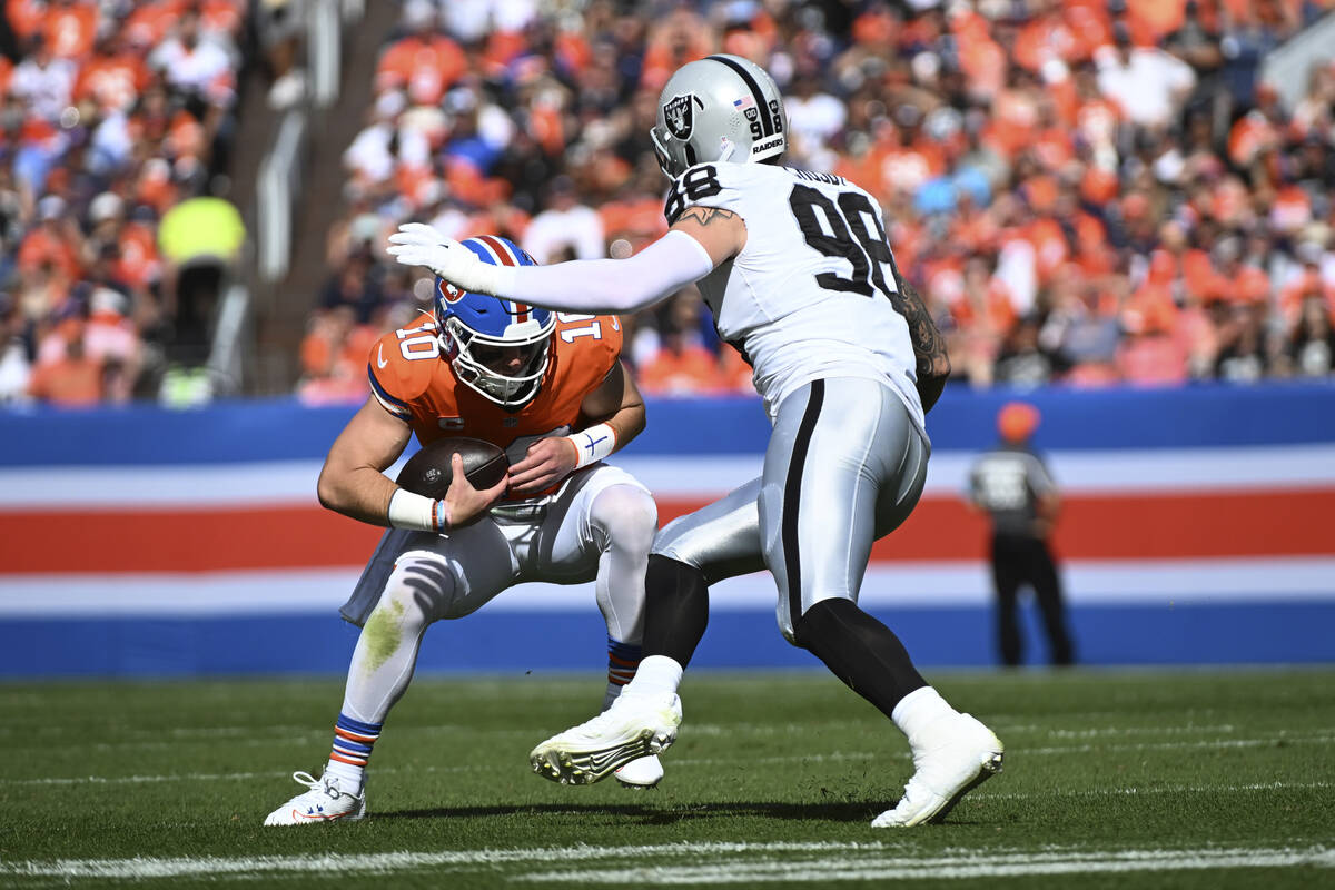 Denver Broncos quarterback Bo Nix (10) is sacked by Las Vegas Raiders defensive end Maxx Crosby ...