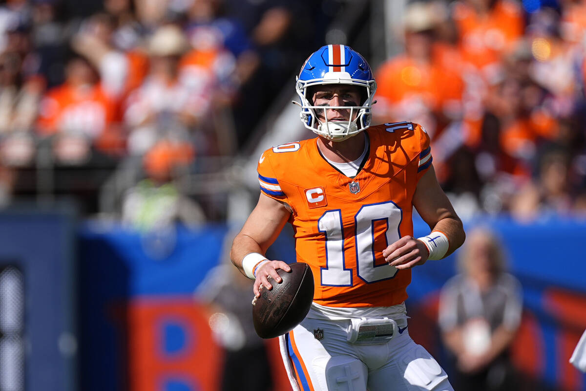 Denver Broncos quarterback Bo Nix looks downfield during the first half of an NFL football game ...