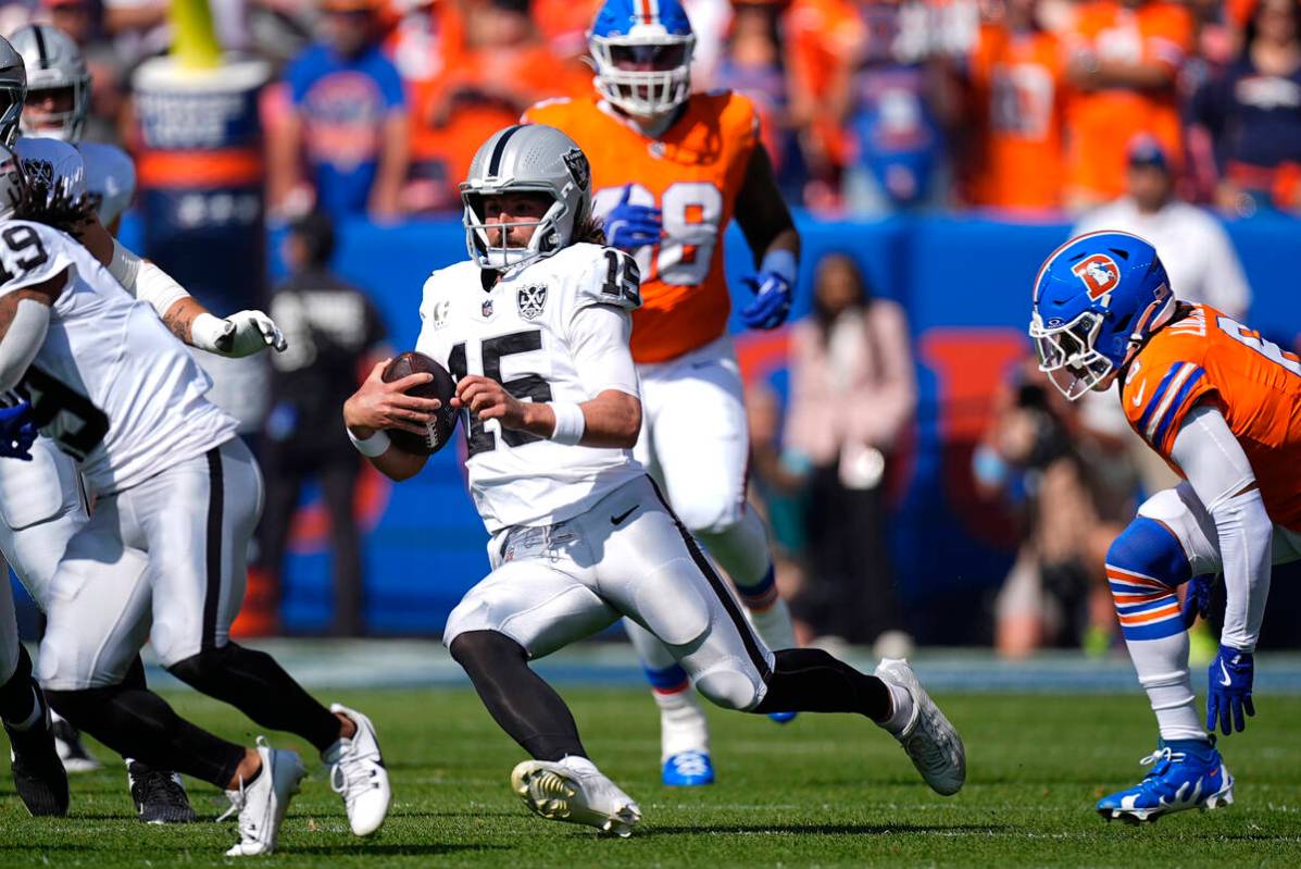 Las Vegas Raiders quarterback Gardner Minshew scrambles during the first half of an NFL footbal ...