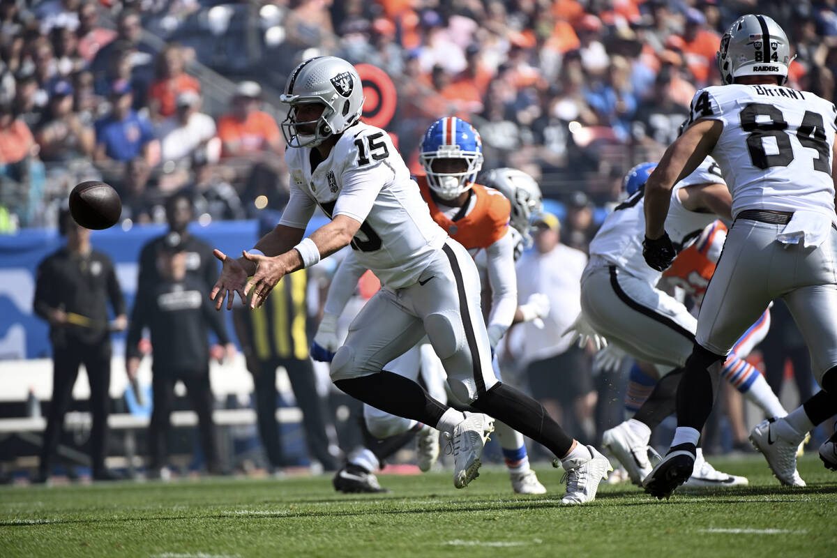 Las Vegas Raiders quarterback Gardner Minshew laterals during the first half of an NFL football ...