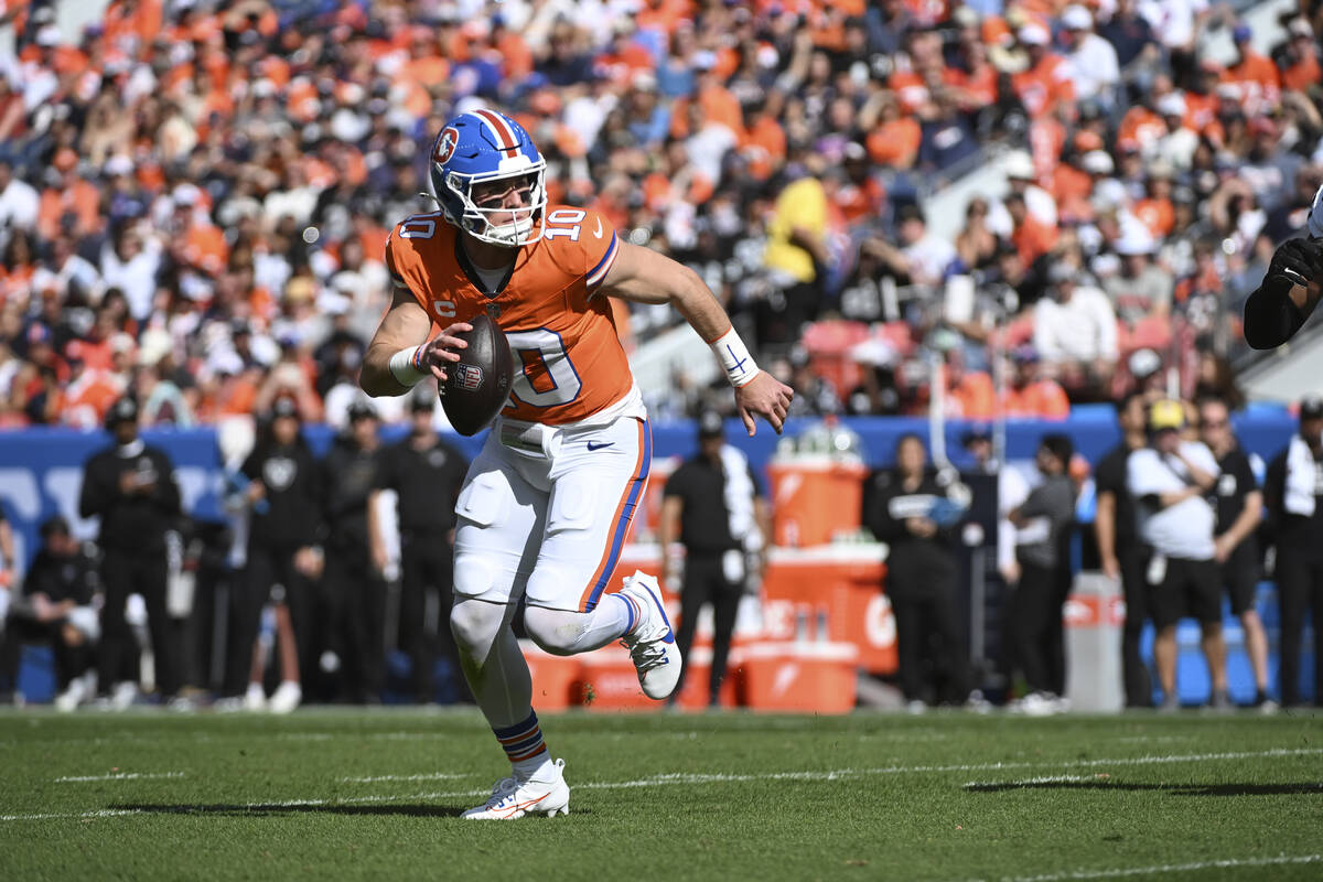 Denver Broncos quarterback Bo Nix scrambles during the first half of an NFL football game again ...