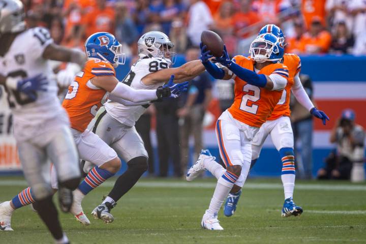 Denver Broncos cornerback Pat Surtain II (2) intercepts a pass intended for Raiders tight end B ...