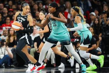 Aces center A'ja Wilson (22) looks for an opening to shoot the ball as New York Liberty forward ...