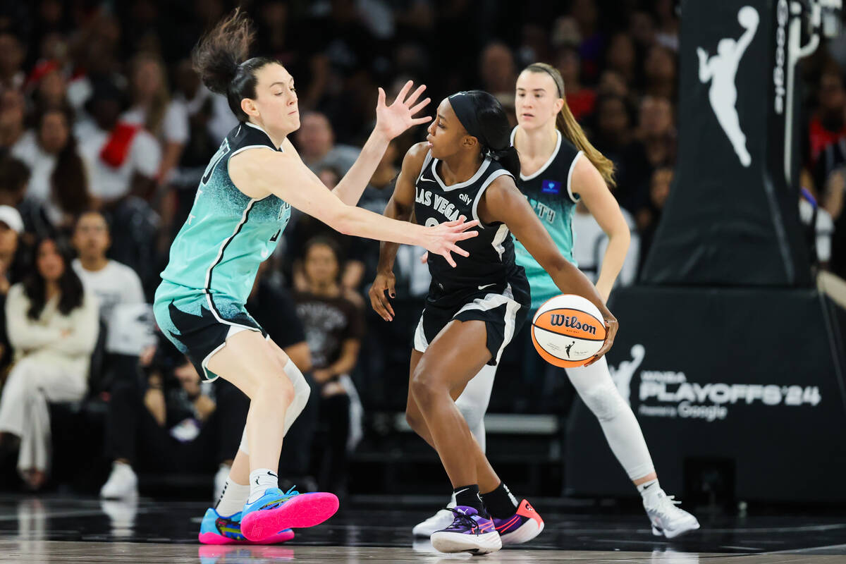 Aces guard Jackie Young (0) moves the ball past New York Liberty forward Breanna Stewart (30) d ...