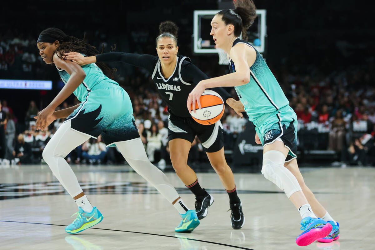 Aces forward Alysha Clark (7) chases down the ball as New York Liberty forward Breanna Stewart ...