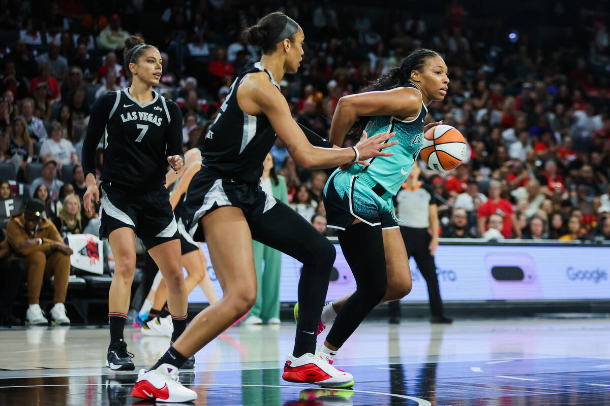 New York Liberty forward Betnijah Laney-Hamilton (44) moves the ball away from Aces center A'ja ...