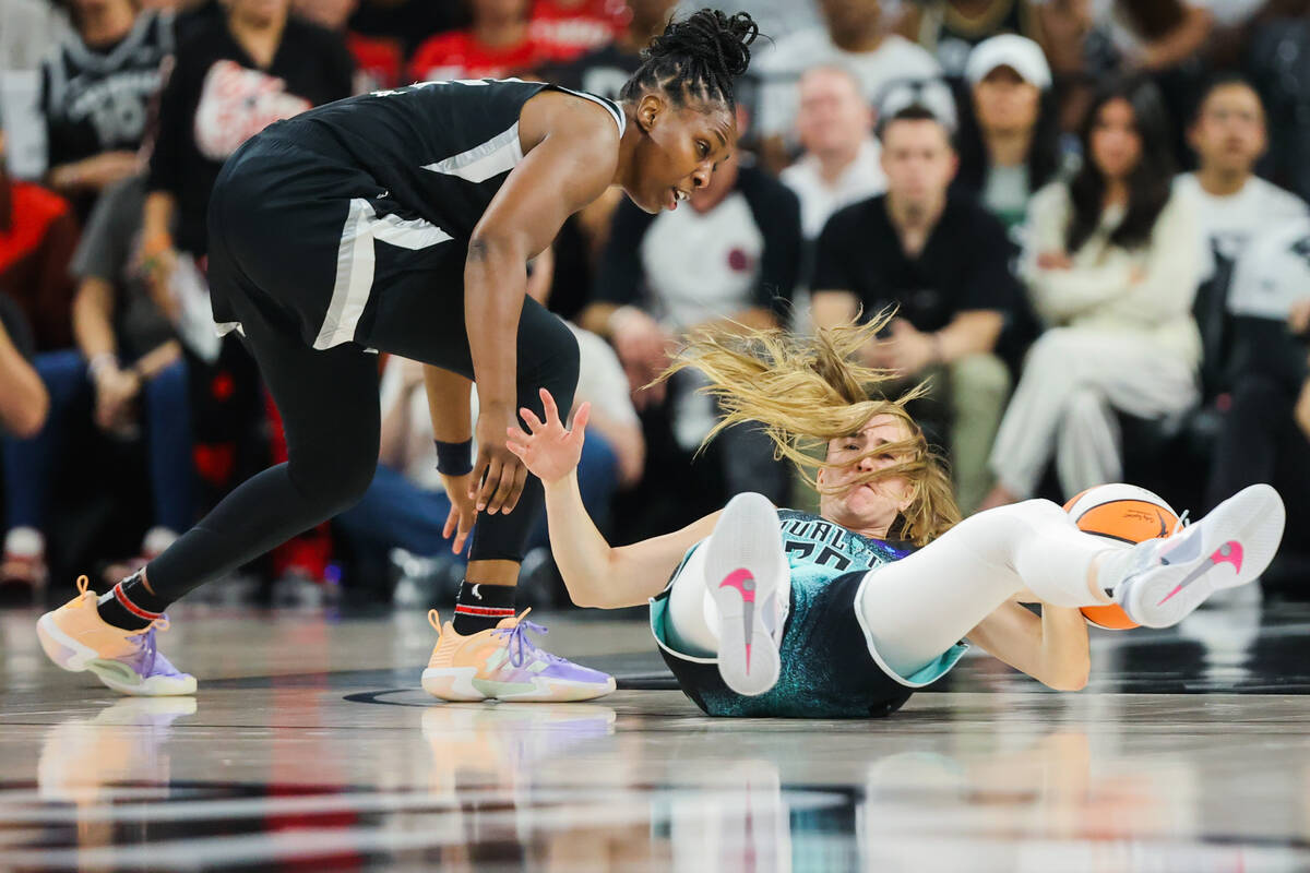 Aces guard Chelsea Gray (12) tries to grab the ball from New York Liberty guard Sabrina Ionescu ...