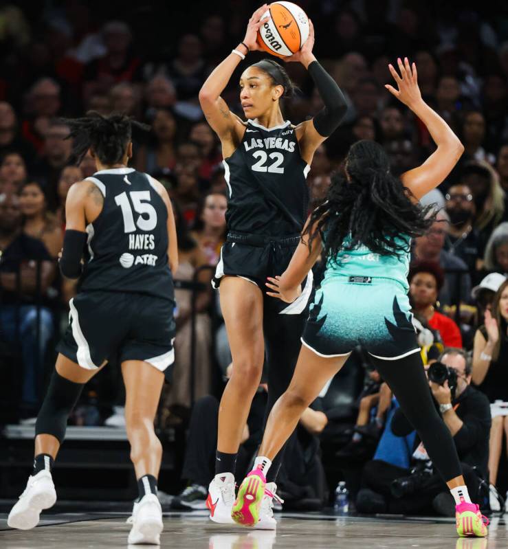 Aces center A'ja Wilson (22) hoists the ball up as she looks for an open teammate during game f ...