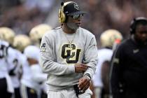 Colorado head coach Deion Sanders walks along the sideline during the first half of an NCAA col ...