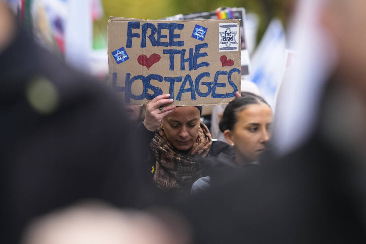 People attend a demonstration in support of Israel to mark the first anniversary of the Hamas a ...