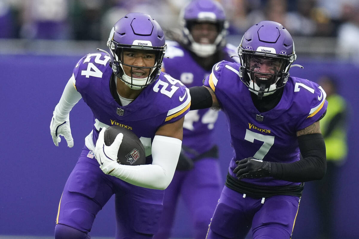 Minnesota Vikings' Camryn Bynum, left, celebrates an interception during the first half of an N ...